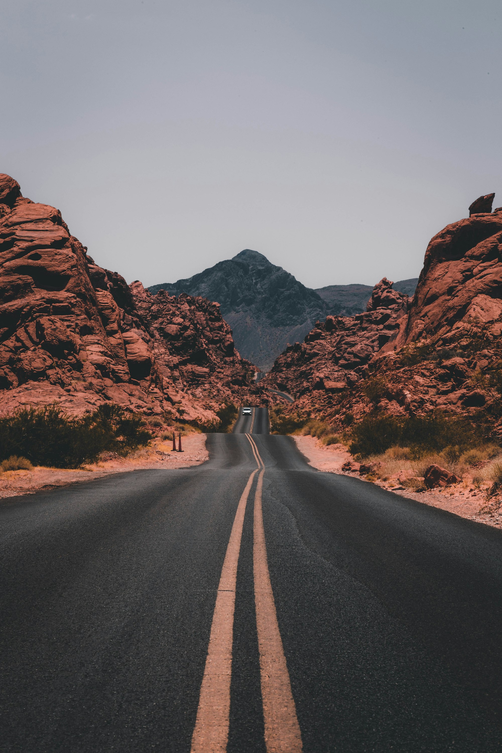 A desert highway winding through red rock canyons